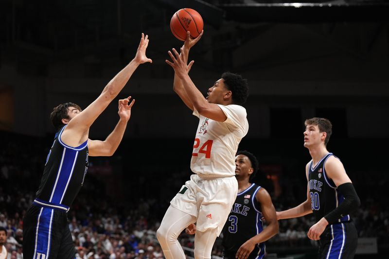 Feb 6, 2023; Coral Gables, Florida, USA; Miami Hurricanes guard Nijel Pack (24) puts up a shot against the Duke Blue Devils during the second half at Watsco Center. Mandatory Credit: Jasen Vinlove-USA TODAY Sports