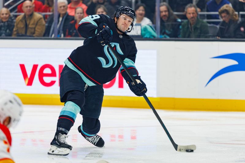 Oct 19, 2024; Seattle, Washington, USA; Seattle Kraken left wing Jared McCann (19) shoots against the Calgary Flames during the first period at Climate Pledge Arena. Mandatory Credit: Caean Couto-Imagn Images