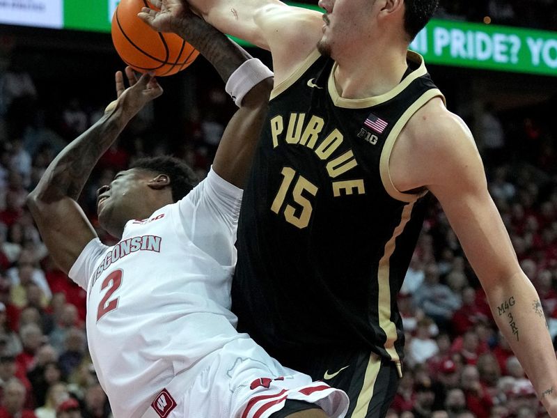 Feb 4, 2024; Madison, Wisconsin, USA; Purdue center Zach Edey (15) fouls Wisconsin guard AJ Storr (2) during the second half at Kohl Center. Mandatory Credit: Mark Hoffman-USA TODAY Sports