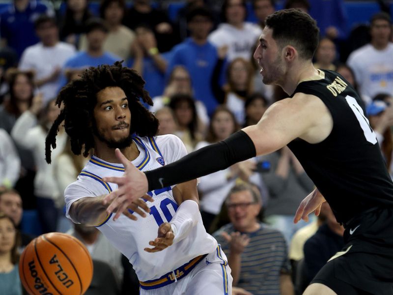 Jan 14, 2023; Los Angeles, California, USA;  UCLA Bruins guard Tyger Campbell (10) passes the ball against Colorado Buffaloes guard Luke O'Brien (0) during the second half at Pauley Pavilion presented by Wescom. Mandatory Credit: Kiyoshi Mio-USA TODAY Sports