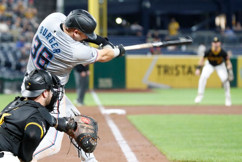 Sep 10, 2024; Pittsburgh, Pennsylvania, USA;  Miami Marlins third baseman Jake Burger (36) hits an RBI single against the Pittsburgh Pirates during the ninth inning at PNC Park. Mandatory Credit: Charles LeClaire-Imagn Images