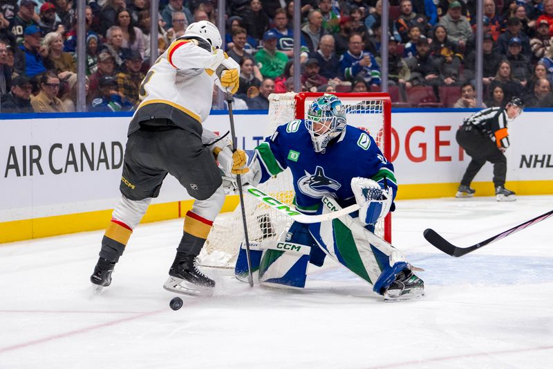 Apr 8, 2024; Vancouver, British Columbia, CAN; Vancouver Canucks goalie Arturs Silvos (31) makes a save on Vegas Golden Knights defenseman Noah Hanifin (15) in the second period  at Rogers Arena. Mandatory Credit: Bob Frid-USA TODAY Sports