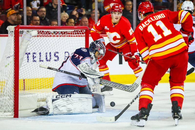 Nov 5, 2025; Calgary, Alberta, CAN; Columbus Blue Jackets goaltender Jet Greaves (73) makes a save against the Calgary Flames during the second period at Scotiabank Saddledome. Mandatory Credit: Sergei Belski-Imagn Images