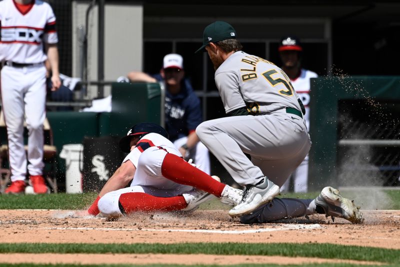 Aug 27, 2023; Chicago, Illinois, USA;  Chicago White Sox first baseman Andrew Vaughn (25) scores past Oakland Athletics starting pitcher Paul Blackburn (58) during the third inning at Guaranteed Rate Field. Mandatory Credit: Matt Marton-USA TODAY Sports