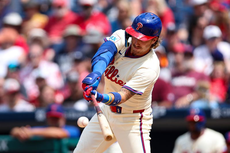 Jul 31, 2024; Philadelphia, Pennsylvania, USA;  Philadelphia Phillies second base Bryson Stott (5) hits a single during the seventh inning against the New York Yankees at Citizens Bank Park. Mandatory Credit: Bill Streicher-USA TODAY Sports