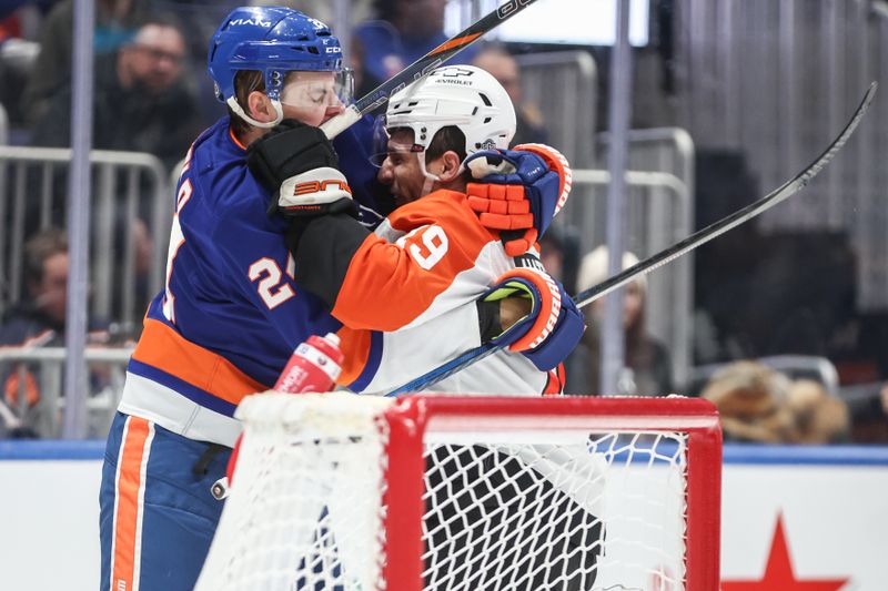 Jan 16, 2025; Elmont, New York, USA;  New York Islanders defenseman Scott Mayfield (24) and Philadelphia Flyers right wing Garnet Hathaway (19) get into a scuffle in the third period at UBS Arena. Mandatory Credit: Wendell Cruz-Imagn Images