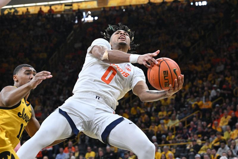 Mar 10, 2024; Iowa City, Iowa, USA; Illinois Fighting Illini guard Terrence Shannon Jr. (0) goes to the basket as Iowa Hawkeyes guard Tony Perkins (11) defends during the first half at Carver-Hawkeye Arena. Mandatory Credit: Jeffrey Becker-USA TODAY Sports