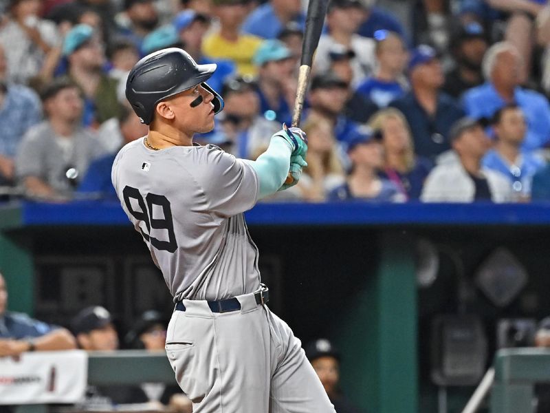 Jun 11, 2024; Kansas City, Missouri, USA; New York Yankees center fielder Aaron Judge (99) hits a two-run home run in the seventh inning against the Kansas City Royals at Kauffman Stadium. Mandatory Credit: Peter Aiken-USA TODAY Sports