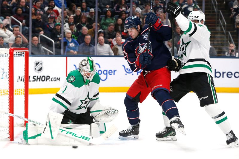 Jan 22, 2026; Columbus, Ohio, USA; Dallas Stars goalie Casey DeSmith (1) makes a pad save as Columbus Blue Jackets center Sean Monahan (23) looks for a rebound during the second period at Nationwide Arena. Mandatory Credit: Russell LaBounty-Imagn Images