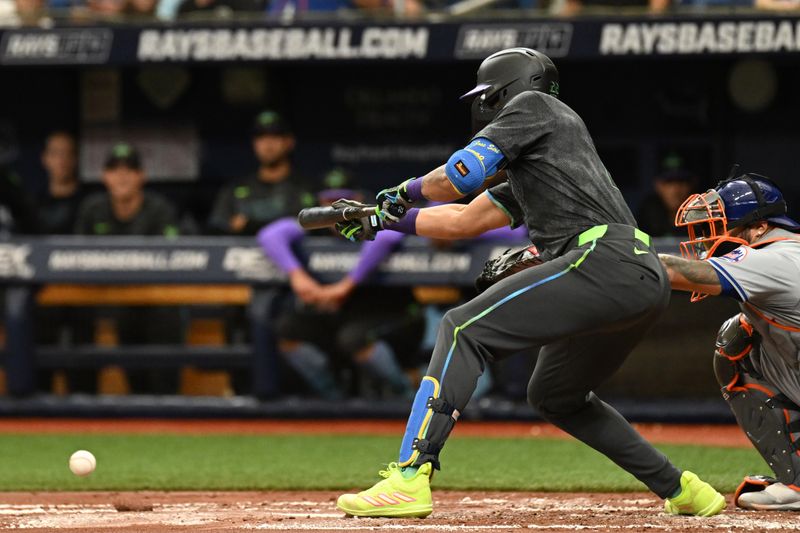 May 5, 2024; St. Petersburg, Florida, USA; Tampa Bay Rays center fielder Jose Siri (22) lays down a sacrifice bunt in the second inning against the New York Mets at Tropicana Field. Mandatory Credit: Jonathan Dyer-USA TODAY Sports