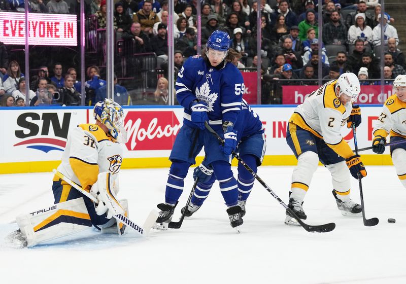 Dec 9, 2023; Toronto, Ontario, CAN; Toronto Maple Leafs left wing Tyler Bertuzzi (59) battles for the puck with Nashville Predators defenseman Luke Schenn (2) in front of goaltender Kevin Lankinen (32) during the first period at Scotiabank Arena. Mandatory Credit: Nick Turchiaro-USA TODAY Sports