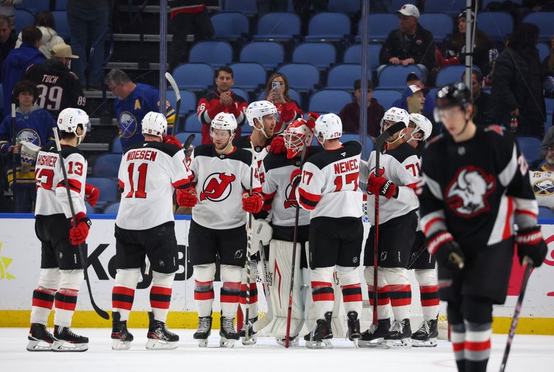 Nov 28, 2025; Buffalo, New York, USA;  The New Jersey Devils celebrate a win over the Buffalo Sabres at KeyBank Center. Mandatory Credit: Timothy T. Ludwig-Imagn Images