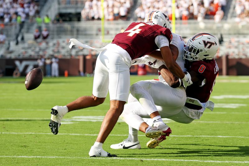 Sep 21, 2024; Blacksburg, Virginia, USA; Virginia Tech Hokies linebacker Keli Lawson (0) forces Rutgers Scarlet Knights tight end Kenny Fletcher (12) to fumbles near the goal line during the second quarter at Lane Stadium. Mandatory Credit: Peter Casey-Imagn Images