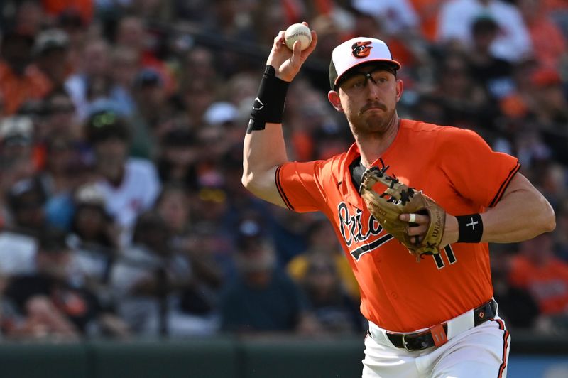 Jun 1, 2024; Baltimore, Maryland, USA;  Baltimore Orioles third baseman Jordan Westburg (11) throws to first base during the third inning against the Tampa Bay Rays at Oriole Park at Camden Yards. Mandatory Credit: Tommy Gilligan-USA TODAY Sports