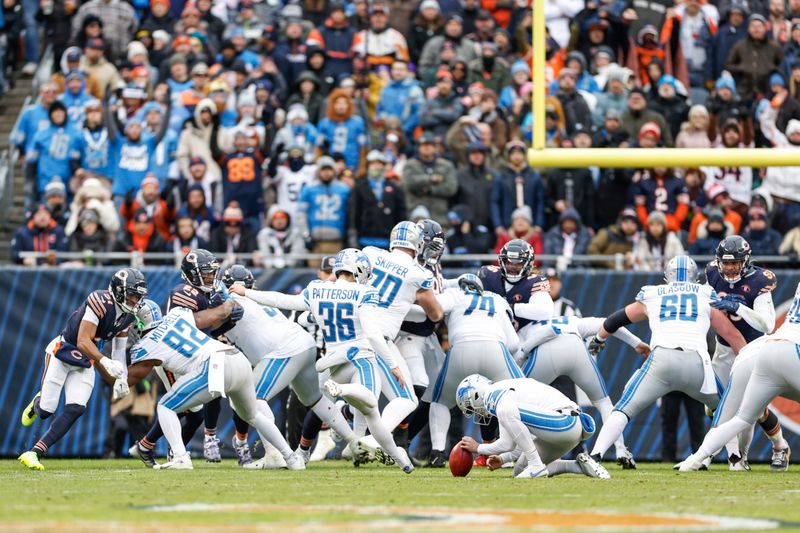 Detroit Lions place kicker Riley Patterson (36) steps into a extra point attempt off the hold of Trenton Gill that sailed left of the goal posts during the first half of an NFL football game against the Chicago Bears, Sunday, Dec. 10, 2023, in Chicago. (AP Photo/Kamil Krzaczynski)