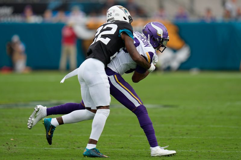 Minnesota Vikings wide receiver Justin Jefferson (18) is tackled by Jacksonville Jaguars cornerback Jarrian Jones (22) after catching a pass during the second half of an NFL football game, Sunday, Nov. 10, 2024, in Jacksonville, Fla. (AP Photo/John Raoux)