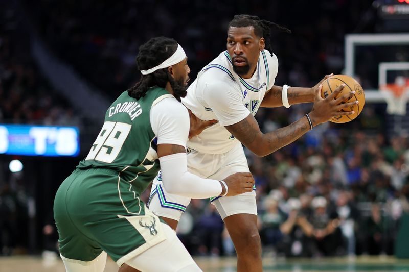 MILWAUKEE, WISCONSIN - FEBRUARY 08: Naz Reid #11 of the Minnesota Timberwolves is defended by Jae Crowder #99 of the Milwaukee Bucks during a game at Fiserv Forum on February 08, 2024 in Milwaukee, Wisconsin. NOTE TO USER: User expressly acknowledges and agrees that, by downloading and or using this photograph, User is consenting to the terms and conditions of the Getty Images License Agreement. (Photo by Stacy Revere/Getty Images)