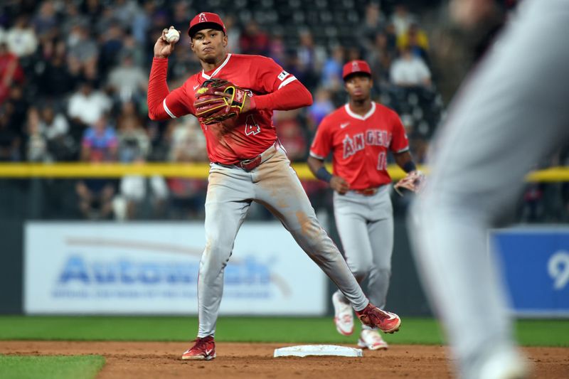 Sep 20, 2025; Denver, Colorado, USA; Los Angeles Angels second base Christian Moore (4) throws to first base for an out during the ninth inning against the Colorado Rockies at Coors Field. Mandatory Credit: Christopher Hanewinckel-Imagn Images