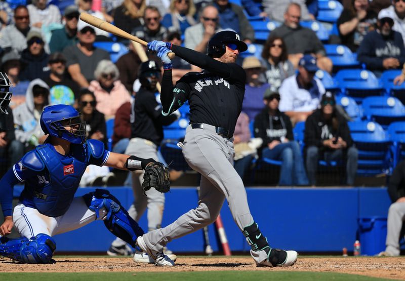 Feb 24, 2026; Dunedin, Florida, USA;  New York Yankees left fielder Cody Bellinger (35) singles during the third inning against the Toronto Blue Jays at TD Ballpark. Mandatory Credit: Kim Klement Neitzel-Imagn Images