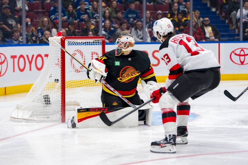 Oct 30, 2024; Vancouver, British Columbia, CAN; New Jersy Devils forward Nico Hischier (13) scores on Vancouver Canucks goalie Arturs Silovs (31) during the first period at Rogers Arena. Mandatory Credit: Bob Frid-Imagn Images