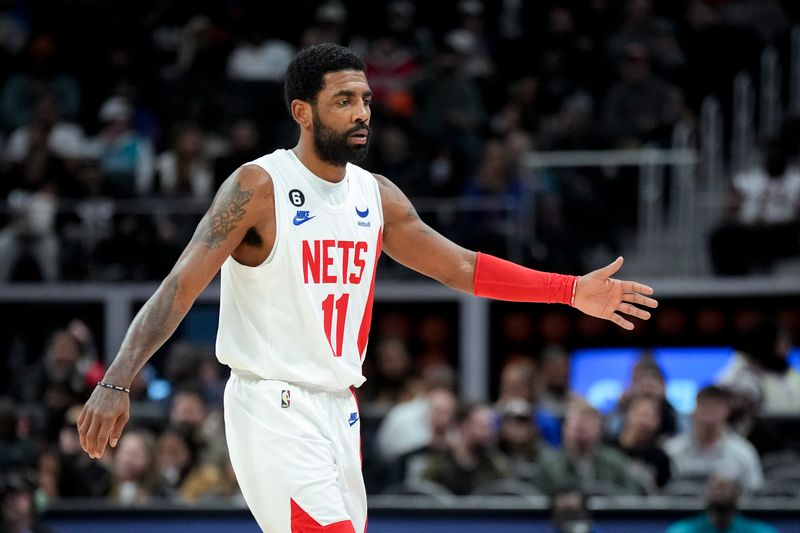 DETROIT, MICHIGAN - DECEMBER 18: Kyrie Irving #11 of the Brooklyn Nets goes for a high five against the Detroit Pistons at Little Caesars Arena on December 18, 2022 in Detroit, Michigan. NOTE TO USER: User expressly acknowledges and agrees that, by downloading and or using this photograph, User is consenting to the terms and conditions of the Getty Images License Agreement. (Photo by Nic Antaya/Getty Images)