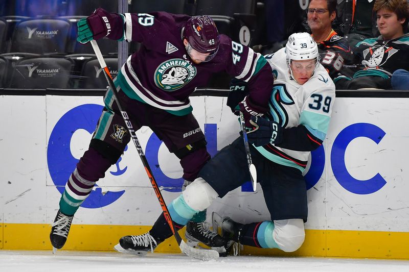 Dec 23, 2023; Anaheim, California, USA; Anaheim Ducks left wing Max Jones (49) hits Seattle Kraken defenseman Ryker Evans (39) while playing for the puck during the third period at Honda Center. Mandatory Credit: Gary A. Vasquez-USA TODAY Sports