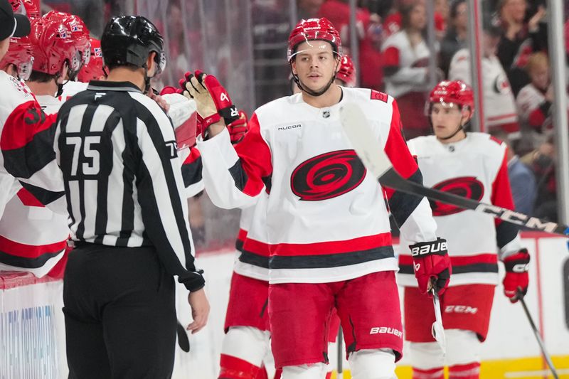 Nov 8, 2025; Raleigh, North Carolina, USA;  Carolina Hurricanes center Jesperi Kotkaniemi (82) celebrates his goal against the Buffalo Sabres during the second period at Lenovo Center. Mandatory Credit: James Guillory-Imagn Images