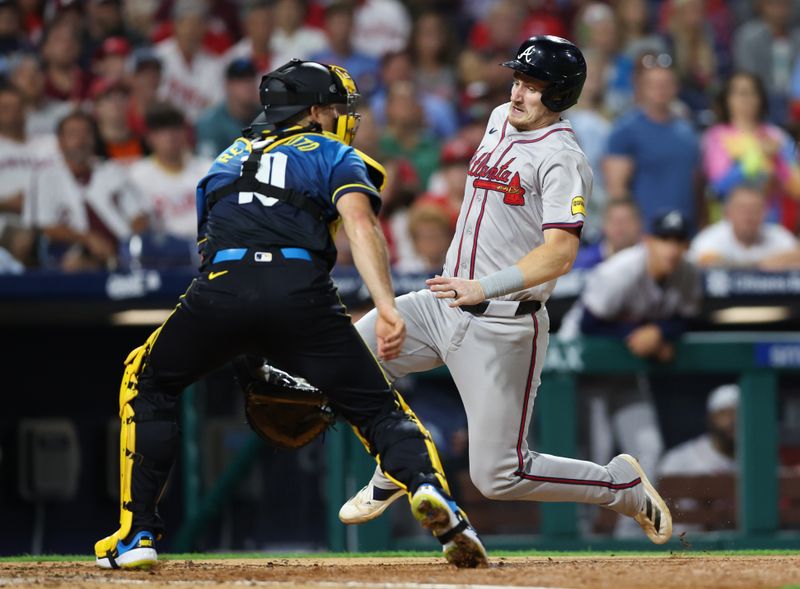 Aug 30, 2024; Philadelphia, Pennsylvania, USA; Atlanta Braves catcher Sean Murphy (12) scores past Philadelphia Phillies catcher J.T. Realmuto (10) during the sixth inning at Citizens Bank Park. Mandatory Credit: Bill Streicher-USA TODAY Sports