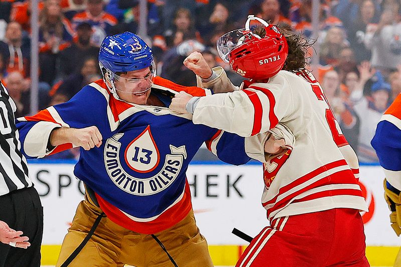 Feb 24, 2024; Edmonton, Alberta, CAN; Edmonton Oilers forward Mattias Janmark (13) and Calgary Flames forward Blake Coleman (20) fight during the second period at Rogers Place. Mandatory Credit: Perry Nelson-USA TODAY Sports