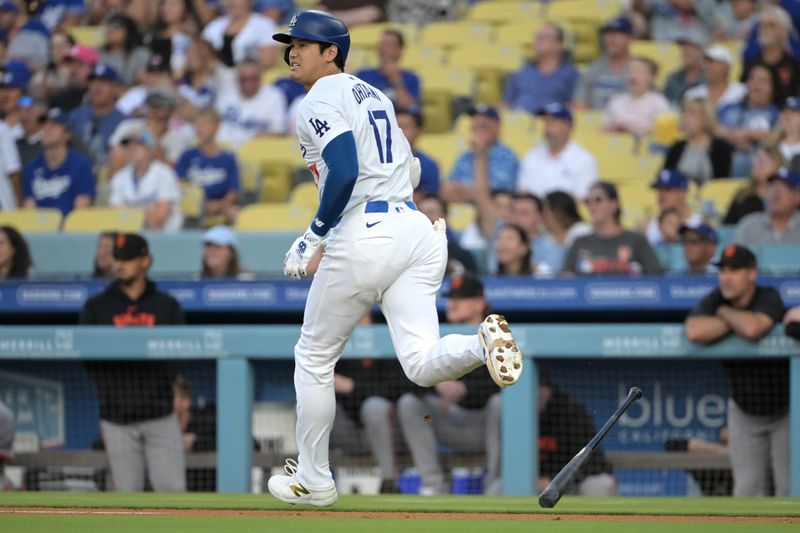 Jul 24, 2024; Los Angeles, California, USA;  Los Angeles Dodgers designated hitter Shohei Ohtani (17) hits a long fly ball for an out in the first inning against the San Francisco Giants at Dodger Stadium. Mandatory Credit: Jayne Kamin-Oncea-USA TODAY Sports