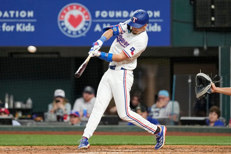 Apr 24, 2024; Arlington, Texas, USA; Texas Rangers left fielder Evan Carter (32) hits a triple against the Seattle Mariners during the seventh inning at Globe Life Field. Mandatory Credit: Jim Cowsert-USA TODAY Sports