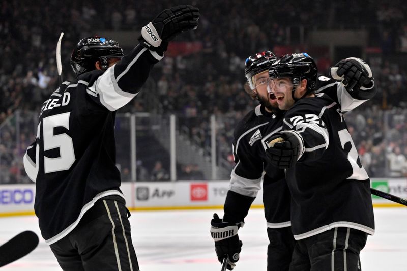 Mar 3, 2024; Los Angeles, California, USA; Los Angeles Kings right wing Quinton Byfield (55) and defenseman Drew Doughty (8) congratulate left wing Kevin Fiala (22) after scoring in the second period against the New Jersey Devils at Crypto.com Arena. Mandatory Credit: Jayne Kamin-Oncea-USA TODAY Sports