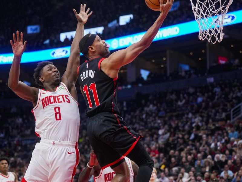 TORONTO, ON - FEBRUARY 9: Bruce Brown #11 of the Toronto Raptors goes to the basket against Jae'Sean Tate #8 of the Houston Rockets during the first half at the Scotiabank Arena on February 9, 2024 in Toronto, Ontario, Canada. NOTE TO USER: User expressly acknowledges and agrees that, by downloading and/or using this Photograph, user is consenting to the terms and conditions of the Getty Images License Agreement. (Photo by Mark Blinch/Getty Images)