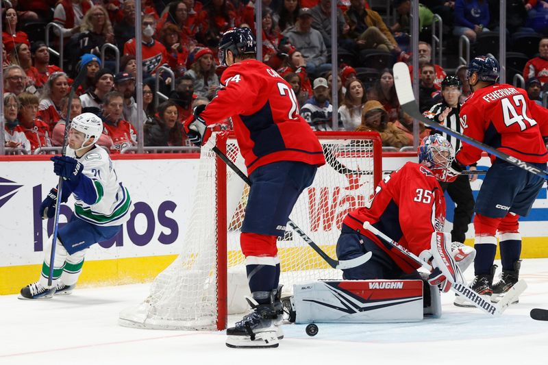 Feb 11, 2024; Washington, District of Columbia, USA; Vancouver Canucks left wing Nils Hoglander (21) celebrates after scoring a goal on Washington Capitals goaltender Darcy Kuemper (35) in the second period at Capital One Arena. Mandatory Credit: Geoff Burke-USA TODAY Sports