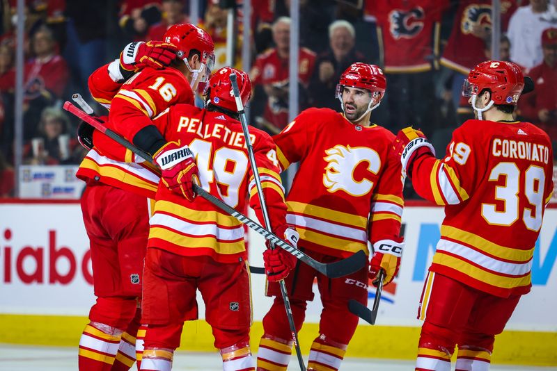 Apr 12, 2023; Calgary, Alberta, CAN; Calgary Flames defenseman Nikita Zadorov (16) celebrates his goal with teammates against the San Jose Sharks during the third period at Scotiabank Saddledome. Mandatory Credit: Sergei Belski-USA TODAY Sports