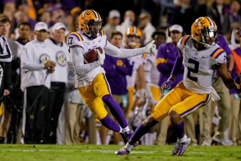 Nov 23, 2019; Baton Rouge, LA, USA; LSU Tigers wide receiver Racey McMath (17) carries the ball against Arkansas Razorbacks during the first half at Tiger Stadium. Mandatory Credit: Stephen Lew-USA TODAY Sports