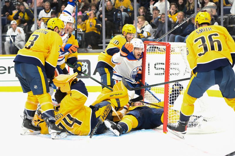 Oct 17, 2024; Nashville, Tennessee, USA;  Edmonton Oilers center Jeff Skinner (53) scores past Nashville Predators goaltender Juuse Saros (74) as left wing Viktor Arvidsson (33) celebrates during the second period at Bridgestone Arena. Mandatory Credit: Steve Roberts-Imagn Images