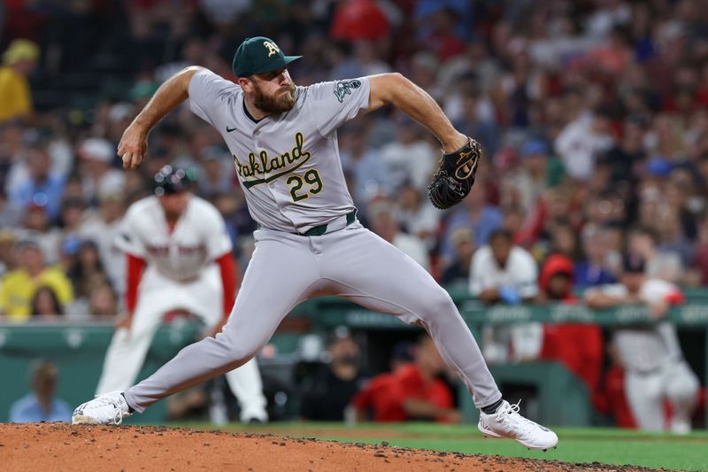 Jul 10, 2024; Boston, Massachusetts, USA; Oakland Athletics relief pitcher Austin Adams (29) delivers a pitch during the sixth inning against the Boston Red Sox at Fenway Park. Mandatory Credit: Paul Rutherford-USA TODAY Sports