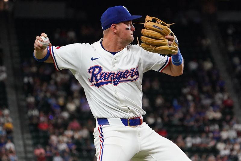 Apr 28, 2025; Arlington, Texas, USA; Texas Rangers third baseman Josh Jung (6) throws to first base for the put out during the fourth inning against the Athletics at Globe Life Field. Mandatory Credit: Raymond Carlin III-Imagn Images