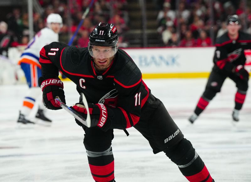 Apr 20, 2024; Raleigh, North Carolina, USA; Carolina Hurricanes center Jordan Staal (11) skates against the New York Islanders during the first period in game one of the first round of the 2024 Stanley Cup Playoffs at PNC Arena. Mandatory Credit: James Guillory-USA TODAY Sports