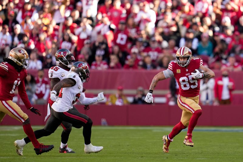 San Francisco 49ers tight end George Kittle, right, runs with the ball after a catch during the second half of an NFL football game against the Tampa Bay Buccaneers on Sunday, Nov. 19, 2023, in Santa Clara, Calif. (AP Photo/Godofredo A. Vásquez)