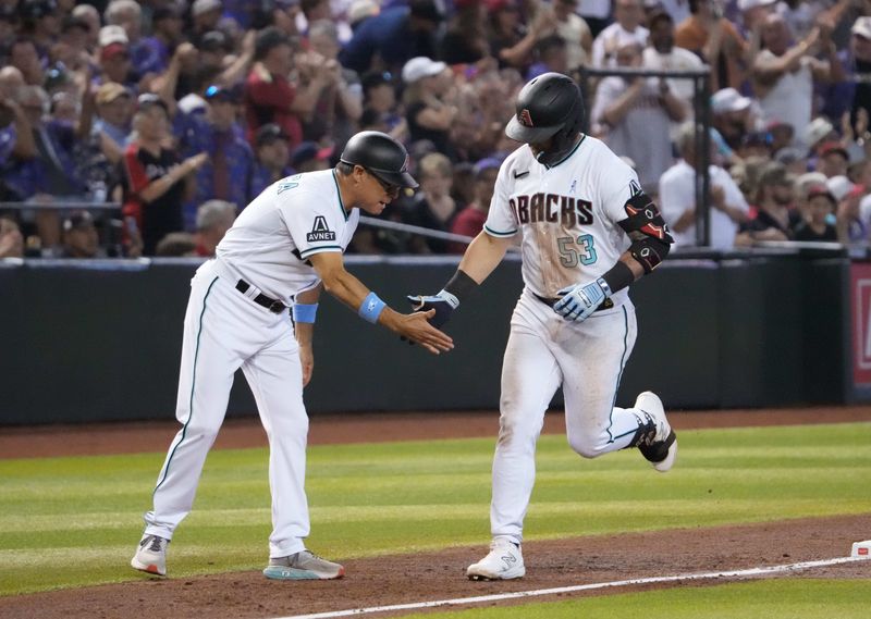 Jun 18, 2023; Phoenix, Arizona, USA; Arizona Diamondbacks first baseman Christian Walker (53) slaps hands with  Arizona Diamondbacks third base coach Tony Perezchica (21) after hitting a solo home run against the Cleveland Guardians during the second inning at Chase Field. Mandatory Credit: Joe Camporeale-USA TODAY Sports