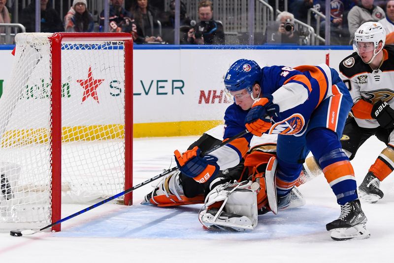 Dec 13, 2023; Elmont, New York, USA; Anaheim Ducks goaltender John Gibson (36) makes a save on New York Islanders right wing Julien Gauthier (16) during the second period at UBS Arena. Mandatory Credit: Dennis Schneidler-USA TODAY Sports