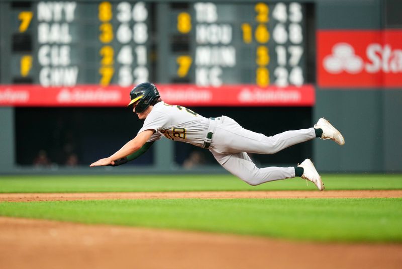 Jul 29, 2023; Denver, Colorado, USA; Oakland Athletics second baseman Zack Gelof (20) dives on a steal attempt in the sixth inning against the Colorado Rockies at Coors Field. Mandatory Credit: Ron Chenoy-USA TODAY Sports