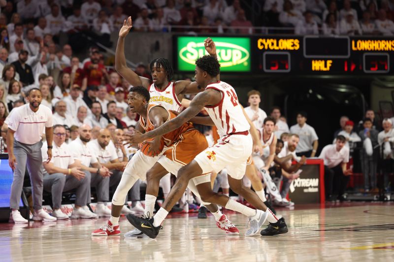 Jan 17, 2023; Ames, Iowa, USA; Texas Longhorns forward Timmy Allen (0) calls a timeout while defended by Iowa State Cyclones guard Eli King (1) and forward Hason Ward (24) during the first half at James H. Hilton Coliseum. Mandatory Credit: Reese Strickland-USA TODAY Sports