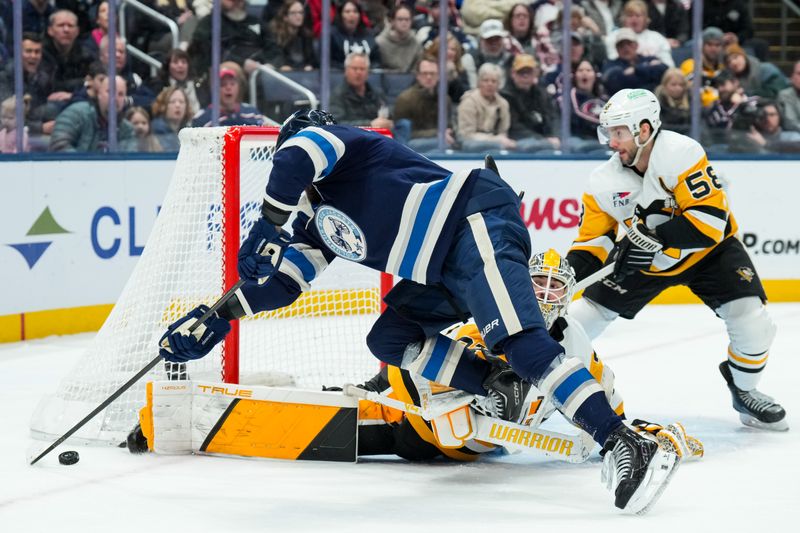 Jan 4, 2026; Columbus, Ohio, USA;  Pittsburgh Penguins goaltender Arturs Silovs (37) defends the net against Columbus Blue Jackets right wing Kirill Marchenko (86) in the third period at Nationwide Arena. Mandatory Credit: Aaron Doster-Imagn Images