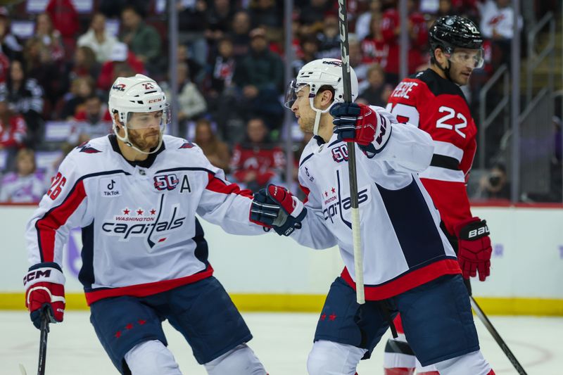 Nov 30, 2024; Newark, New Jersey, USA; Washington Capitals left wing Andrew Mangiapane (88) celebrates his goal with teammate Washington Capitals center Nic Dowd (26) against the New Jersey Devils during the first period at Prudential Center. Mandatory Credit: Thomas Salus-Imagn Images