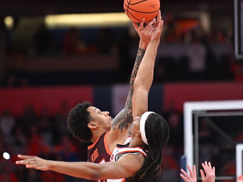 Feb 27, 2024; Syracuse, New York, USA; Virginia Tech Hokies center Lynn Kidd (15) and Syracuse Orange forward Maliq Brown (1) take the opening tip off in the first half at the JMA Wireless Dome. Mandatory Credit: Mark Konezny-USA TODAY Sports