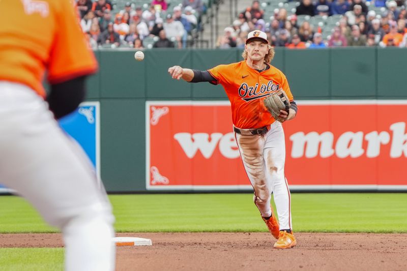 Apr 27, 2024; Baltimore, Maryland, USA; Baltimore Orioles shortstop Gunnar Henderson (2) turns a double play against the Oakland Athletics during the fifth inning at Oriole Park at Camden Yards. Mandatory Credit: Gregory Fisher-USA TODAY Sports