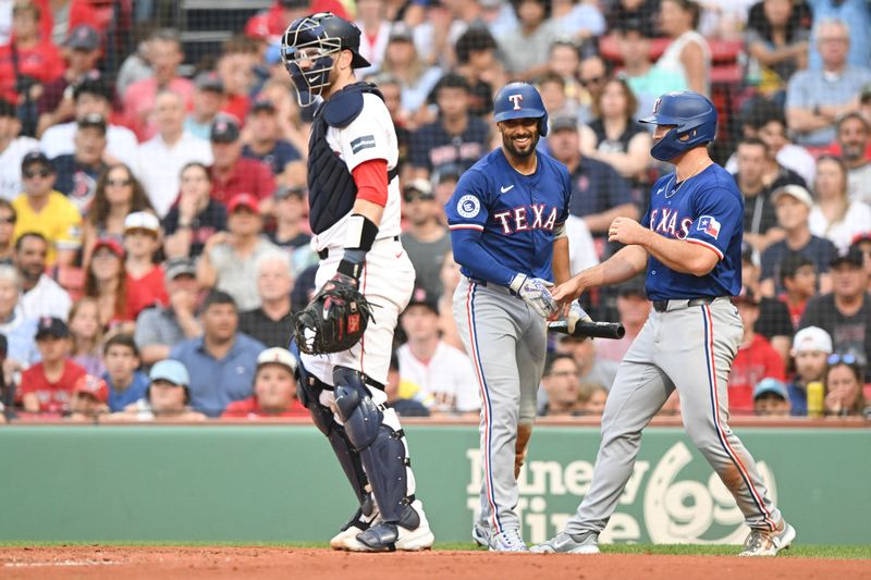 Aug 14, 2024; Boston, Massachusetts, USA; Texas Rangers left fielder Wyatt Langford (36) celebrates with second baseman Marcus Semien (2) after scoring a run against the Boston Red Sox  during the second inning at Fenway Park. Mandatory Credit: Brian Fluharty-USA TODAY Sports